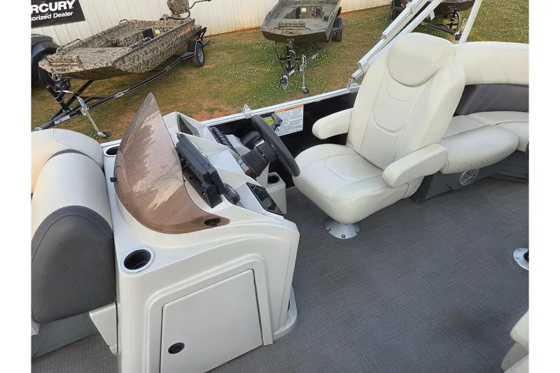 Slide: The Image of 2022 Sylvan Mirage 820 Cruise boat interior with captain's chair and control console. - 15