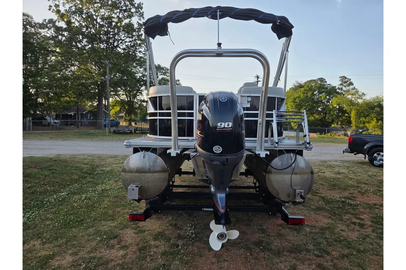 Slide: The Image of 2022 Sylvan Mirage 820 Cruise pontoon boat with Yamaha 90 engine, parked outdoors. - 5