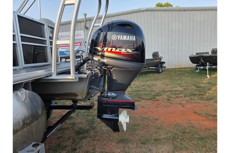 Slide: The Image of 2022 Sylvan Mirage 820 Cruise with Yamaha VMAX outboard motor, parked outdoors. - 6