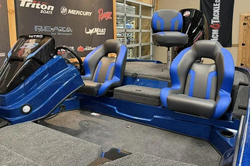 Slide: The Image of 2026 Nitro Z18 Pro boat interior with blue and gray seating, showcased at a dealership. - 11
