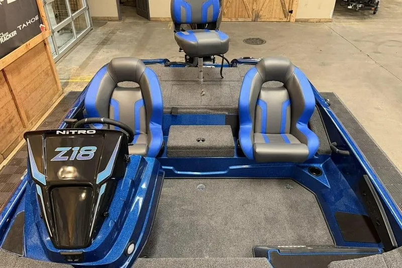 Slide: The Image of 2026 Nitro Z18 Pro boat interior with blue and gray seating, showcasing modern design. - 4