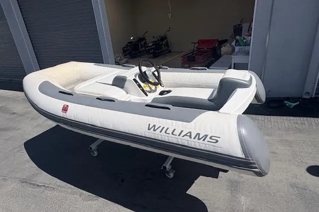 Slide: The Image of 2017 Williams 280 Mini Jet inflatable boat in a garage setting. - 3