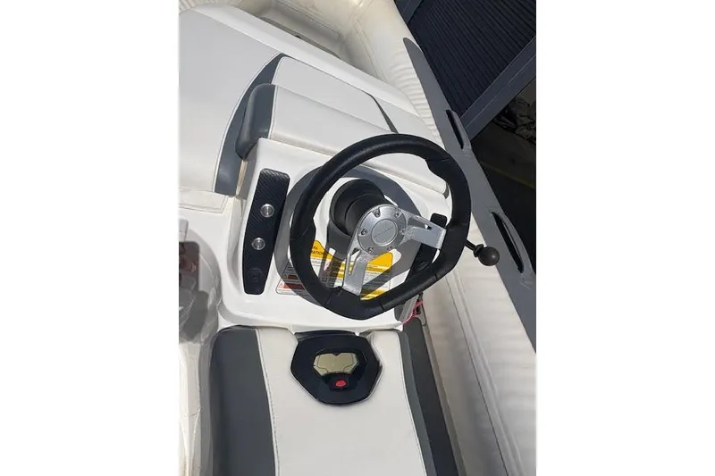 Slide: The Image of Steering console of a 2017 Williams 280 Mini Jet boat, featuring sleek design and controls. - 4