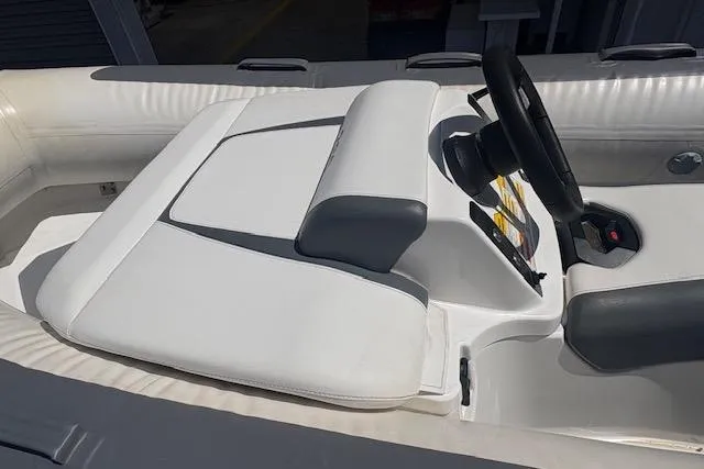 Slide: The Image of 2017 Williams 280 Mini Jet boat interior with white seating and steering wheel. - 5