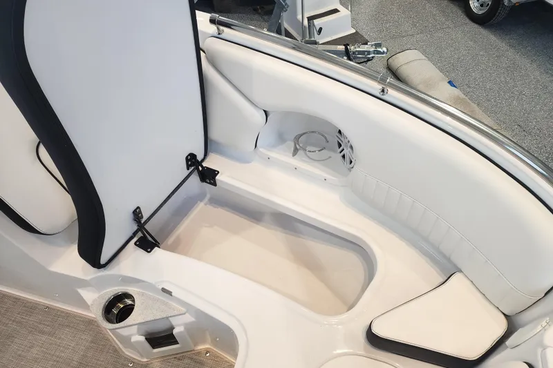Slide: The Image of 2026 Stingray 211 DC boat interior with white seating and storage compartment. - 11