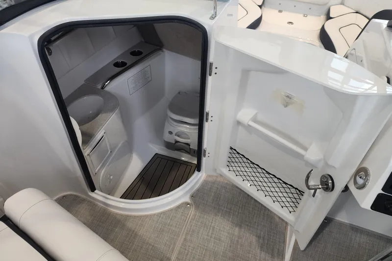 Slide: The Image of 2026 Stingray 211 DC boat interior with compact bathroom and modern amenities. - 14