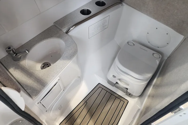 Slide: The Image of Compact bathroom in 2026 Stingray 211 DC boat with sink and portable toilet. - 15