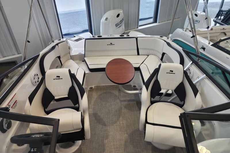 Slide: The Image of Interior of 2026 Stingray 211 DC boat with seating and table arrangement. - 17