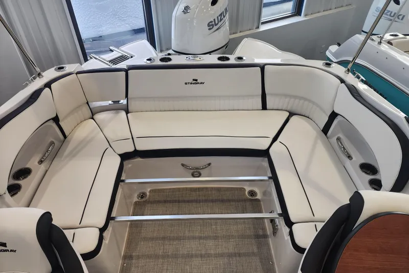 Slide: The Image of 2026 Stingray 211 DC boat interior with white cushioned seating and modern design. - 20