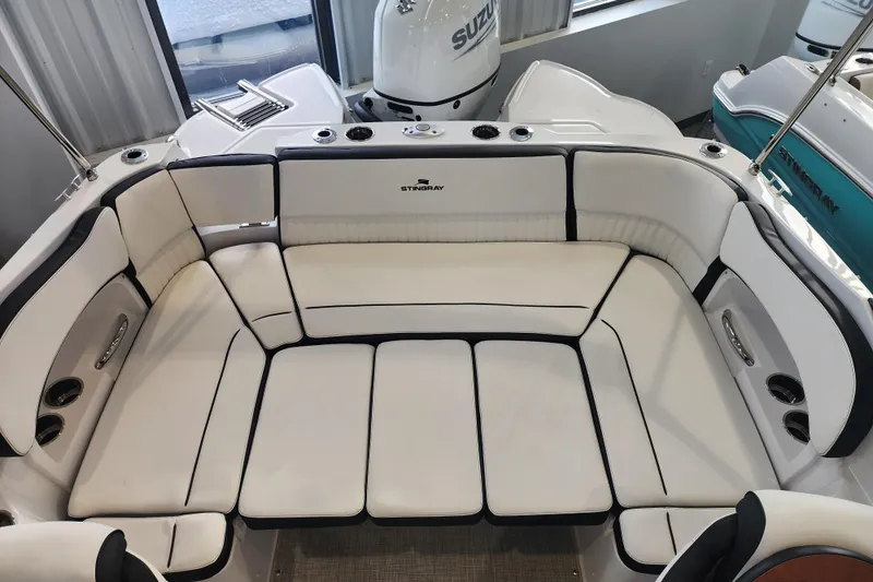 Slide: The Image of 2026 Stingray 211 DC boat interior with white cushioned seating and sleek design. - 21