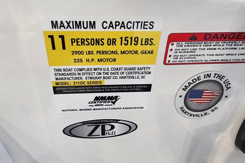 Slide: The Image of 2026 Stingray 211 DC boat capacity label, 11 persons or 1519 lbs, 225 HP motor, made in USA. - 22