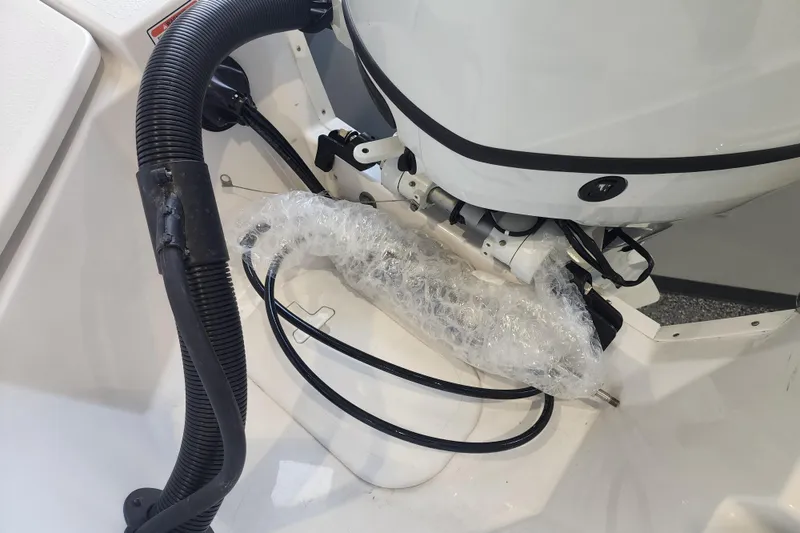 Slide: The Image of 2026 Stingray 211 DC boat engine area with wrapped components and cables. - 25