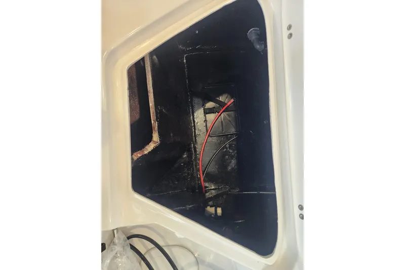 Slide: The Image of Storage compartment of 2026 Stingray 211 DC boat, featuring wiring and interior details. - 26
