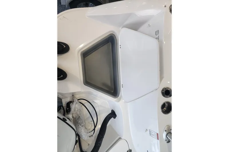 Slide: The Image of 2026 Stingray 211 DC boat interior with storage compartment and control panel. - 27