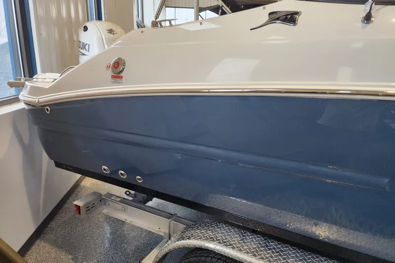 Slide: The Image of 2026 Stingray 211 DC boat on trailer, featuring sleek blue and white design. - 3
