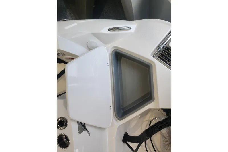 Slide: The Image of 2026 Stingray 211 DC boat interior with open storage compartment and sleek design. - 33