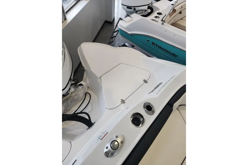 Slide: The Image of 2026 Stingray 211 DC boat interior, featuring sleek white seating and modern controls. - 34