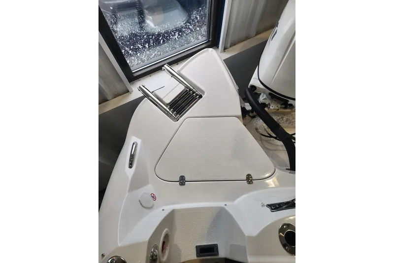Slide: The Image of 2026 Stingray 211 DC boat interior with sleek white design and stainless steel fittings. - 35
