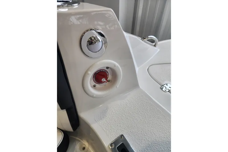 Slide: The Image of 2026 Stingray 211 DC boat dashboard with control knob and textured surface. - 36