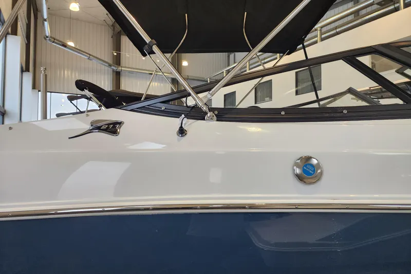 Slide: The Image of 2026 Stingray 211 DC boat in showroom, featuring sleek design and modern detailing. - 4