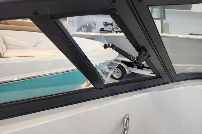 Slide: The Image of 2026 Stingray 211 DC boat interior, showcasing window design and seating details. - 40