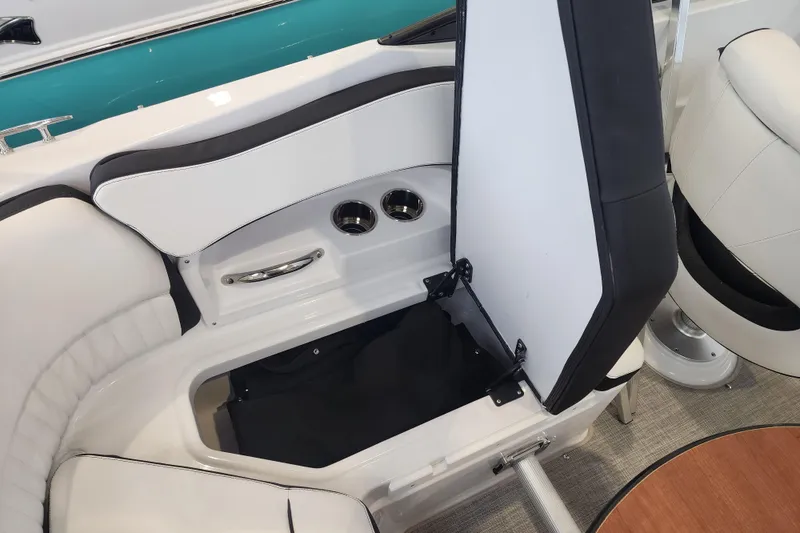 Slide: The Image of 2026 Stingray 211 DC boat interior with open storage compartment and seating. - 42