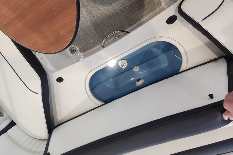 Slide: The Image of Interior view of 2026 Stingray 211 DC boat, featuring seating and storage compartment. - 43