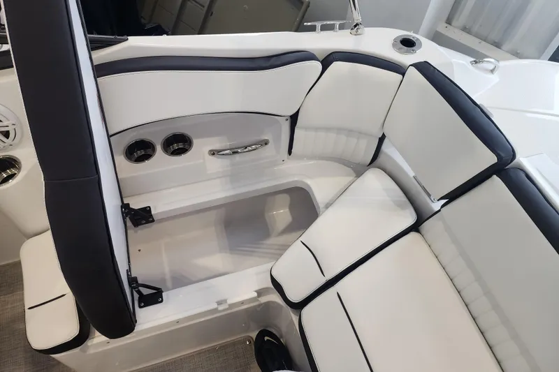 Slide: The Image of 2026 Stingray 211 DC boat interior with white and black cushioned seating. - 44