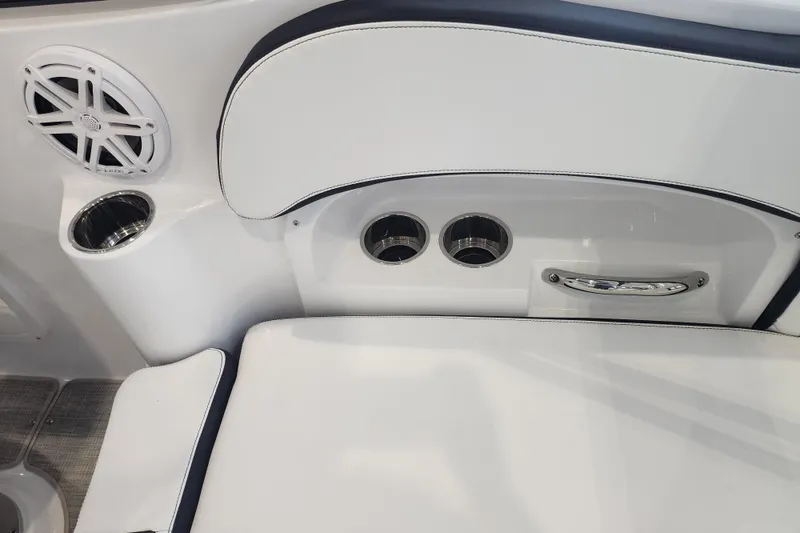Slide: The Image of Interior of 2026 Stingray 211 DC boat featuring cup holders and speaker. - 45