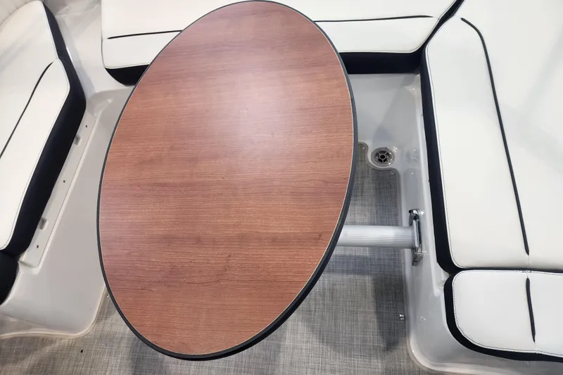 Slide: The Image of Oval wooden table in 2026 Stingray 211 DC boat with white cushioned seating. - 50