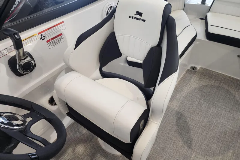 Slide: The Image of Captain's seat in 2026 Stingray 211 DC boat, featuring sleek design and comfortable upholstery. - 52