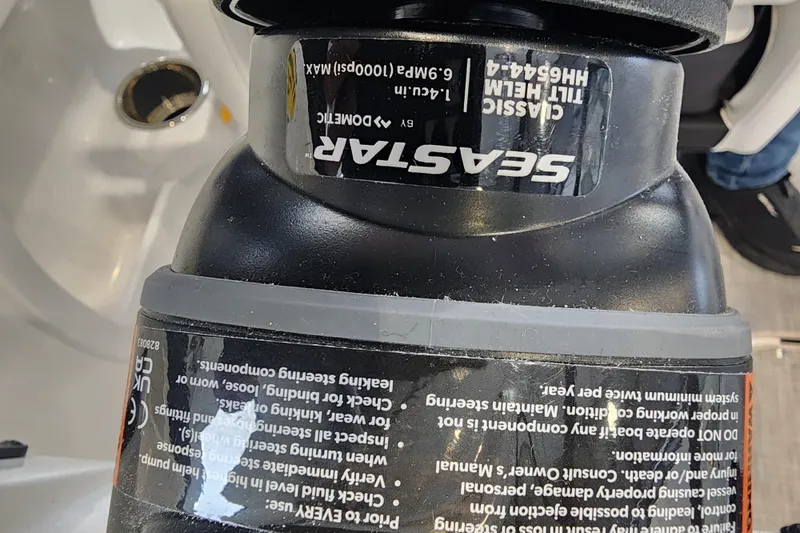 Slide: The Image of Close-up of Seastar hydraulic steering component on a 2026 Stingray 211 DC boat. - 53