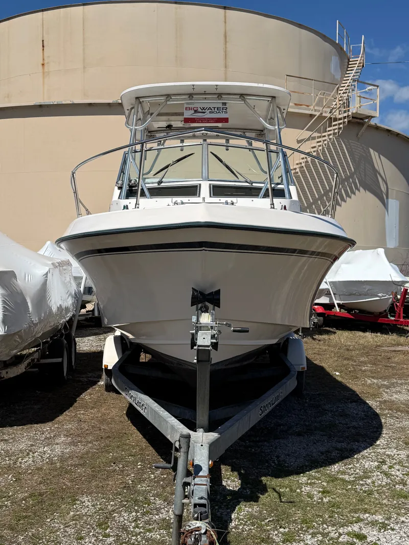 Slide: The Image of 1996 Grady-White Gulfstream 232 boat on trailer in front of tank. - 5