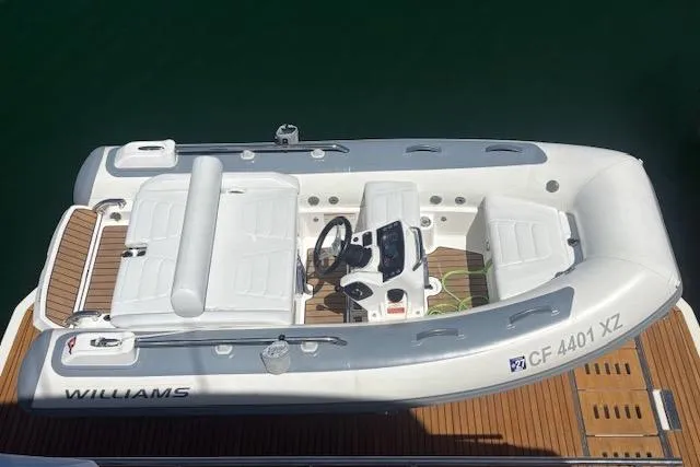 The Image of 2024 Williams Jet Tenders Sportjet 345, white inflatable boat, docked on wooden platform. - 1