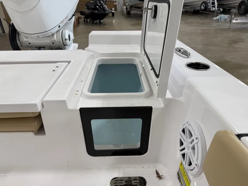 Slide: The Image of 2026 Sportsman Masters 227 Bay Boat with open storage compartment. - 10