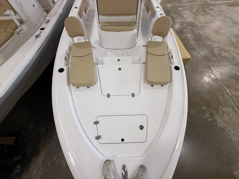 Slide: The Image of Sportsman Masters 227 Bay Boat 2026 with beige seats and storage compartments. - 7