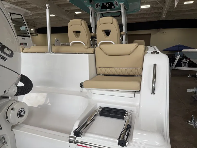 Slide: The Image of 2026 Sportsman Heritage 261 Center Console with beige seating and ladder. - 14