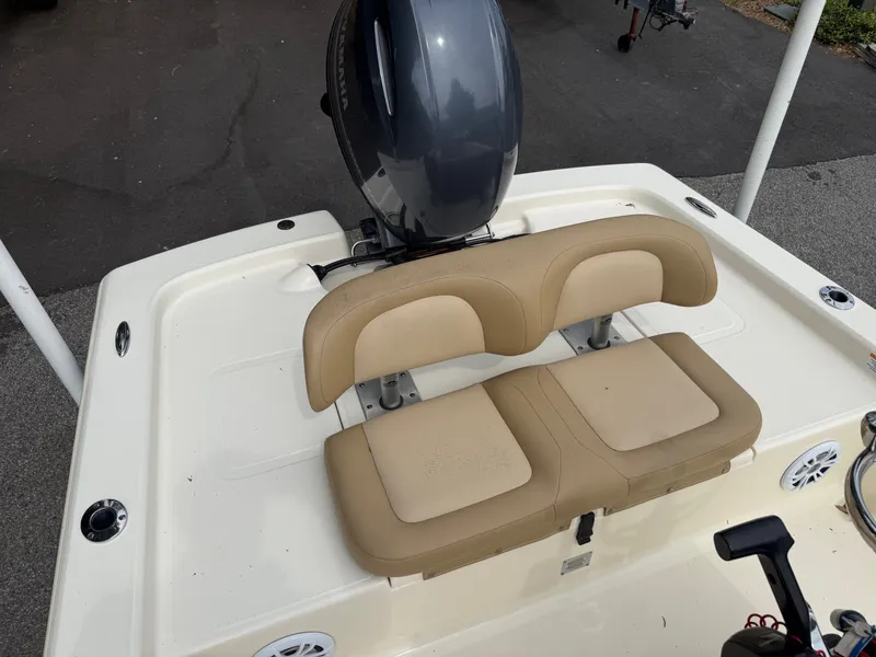 Slide: The Image of 2021 Scout 177 Sport boat with beige seating and outboard motor. - 10