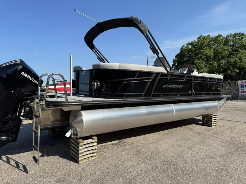 Slide: The Image of Starcraft EXS 5 R DH 2026 pontoon boat elevated on wooden blocks. - 9