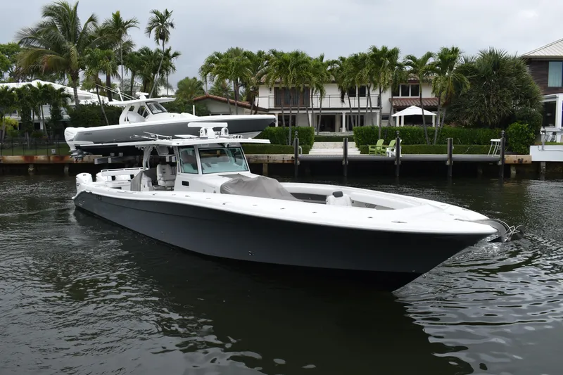 The Image of 2019 HCB 53 Suenos boat cruising near waterfront homes with palm trees. - 0