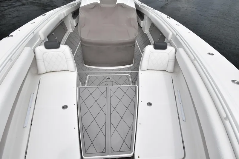 Slide: The Image of 2019 HCB 53 Suenos boat interior with cushioned seating and covered console. - 11