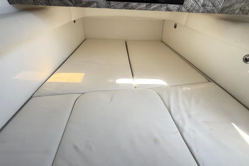 Slide: The Image of Interior cabin of 2019 HCB 53 Suenos boat with white cushioned seating. - 12