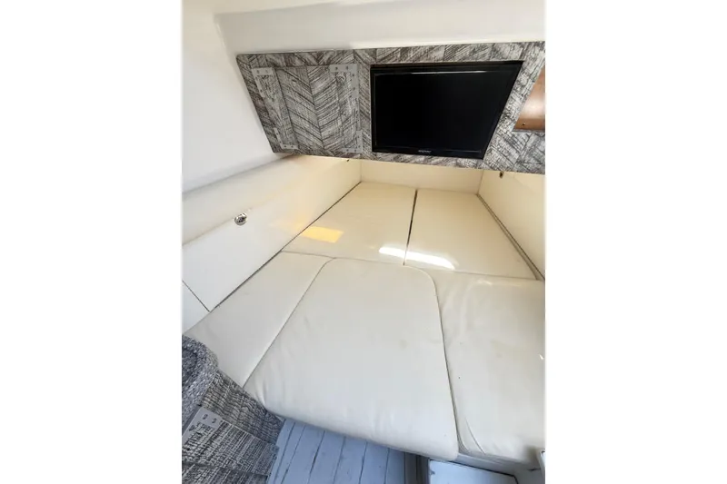 Slide: The Image of Interior cabin of 2019 HCB 53 Suenos boat with TV and cushioned seating. - 15