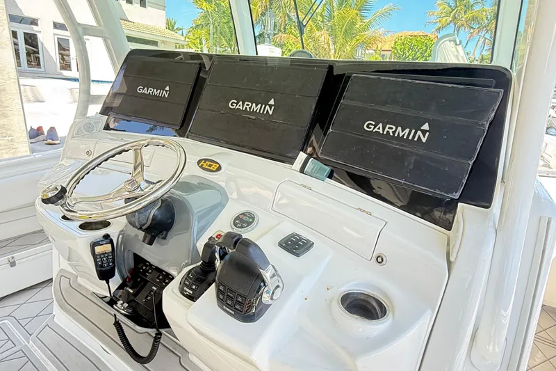 Slide: The Image of Helm of 2019 HCB 53 Suenos with Garmin navigation displays and controls. - 17