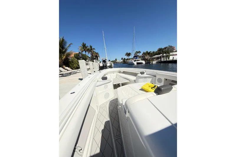 Slide: The Image of 2019 HCB 53 Suenos boat docked by palm trees under clear blue sky. - 19