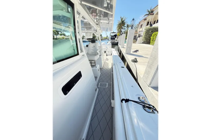 Slide: The Image of 2019 HCB 53 Suenos boat docked, showcasing sleek design and spacious deck. - 20