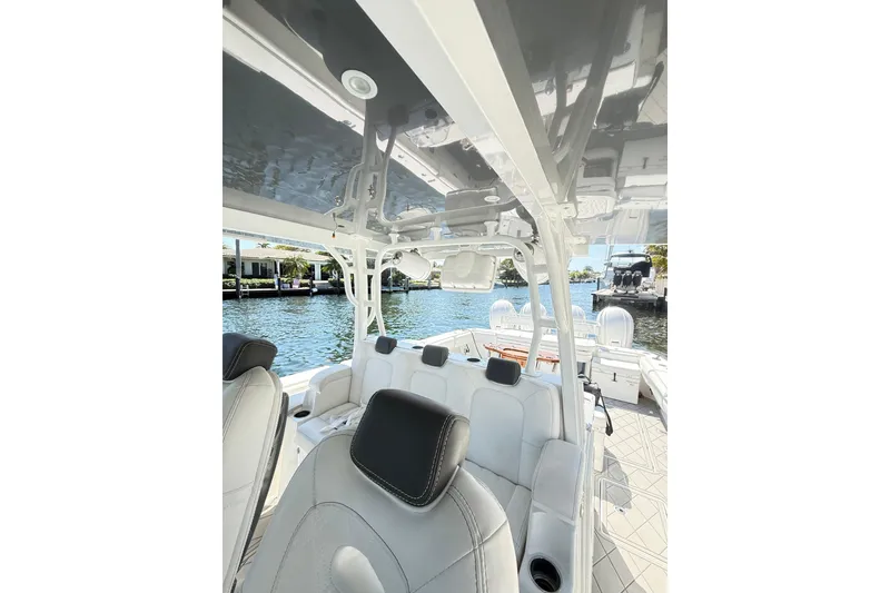 Slide: The Image of Interior view of 2019 HCB 53 Suenos boat with luxurious seating and waterfront backdrop. - 22