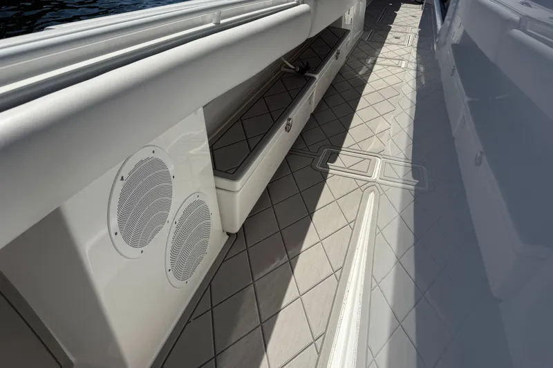 Slide: The Image of Interior view of 2019 HCB 53 Suenos boat, featuring sleek seating and speakers. - 25