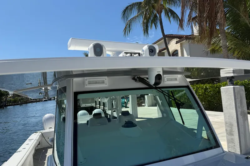 Slide: The Image of 2019 HCB 53 Suenos boat docked by waterfront, featuring advanced navigation equipment. - 27