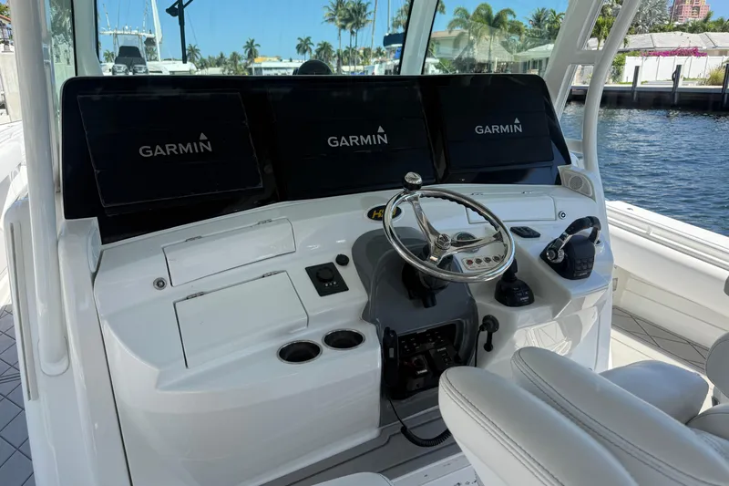 Slide: The Image of 2019 HCB 53 Suenos boat helm with Garmin navigation displays and steering wheel. - 29